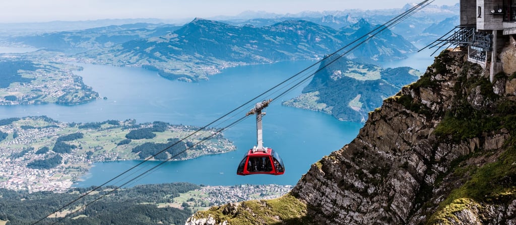 Mount Pilatus cable car with mountains and lake Switzerland