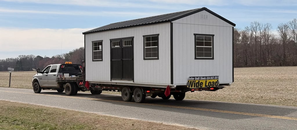 Shed being delivered on the back of a truck and trailer