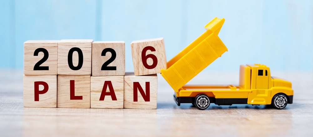 a toy truck with a dump truck in the background