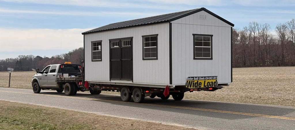 Shed being delivered on the back of a truck and trailer