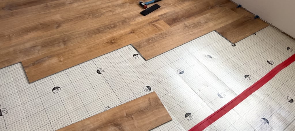 Plank flooring layed over waterproofing underlayment pad.