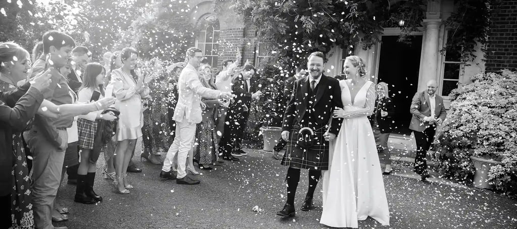 Isabella and Doug having a confetti moment outside Morden Park House