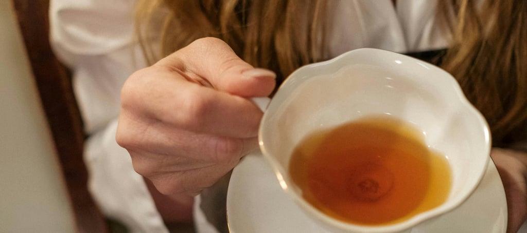 woman holding cup of tea