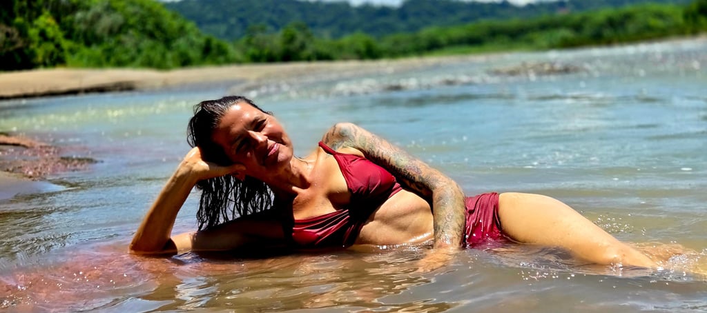 a woman in a bikini laying in water