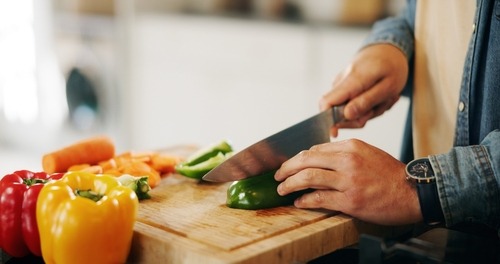 a person is cutting up peppers on a cutting board