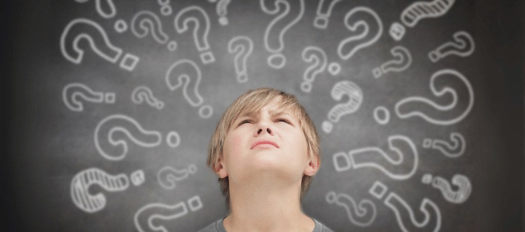 Confused boy with question marks around his head, representing ADHD processing challenges