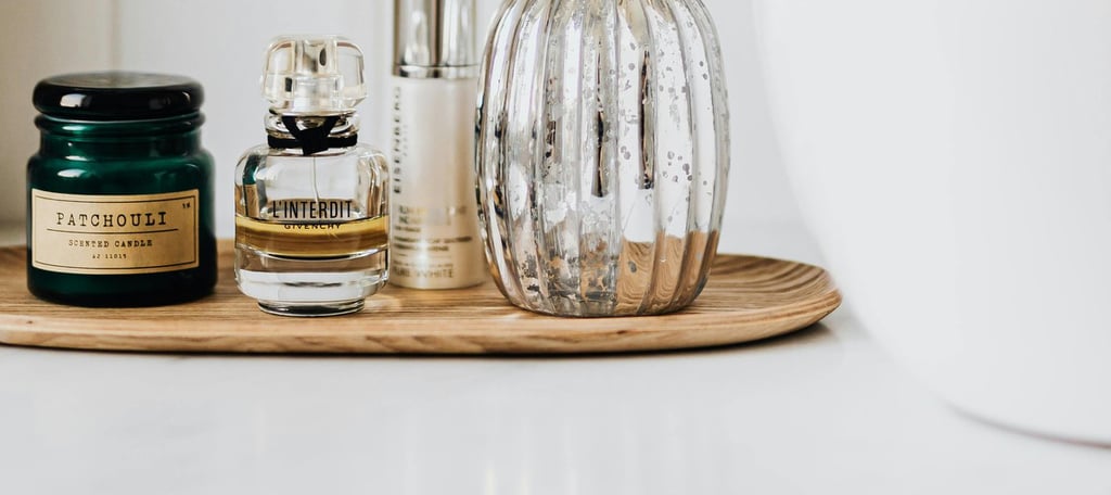 f perfuma bathroom sink with a mirror and a bottle oe