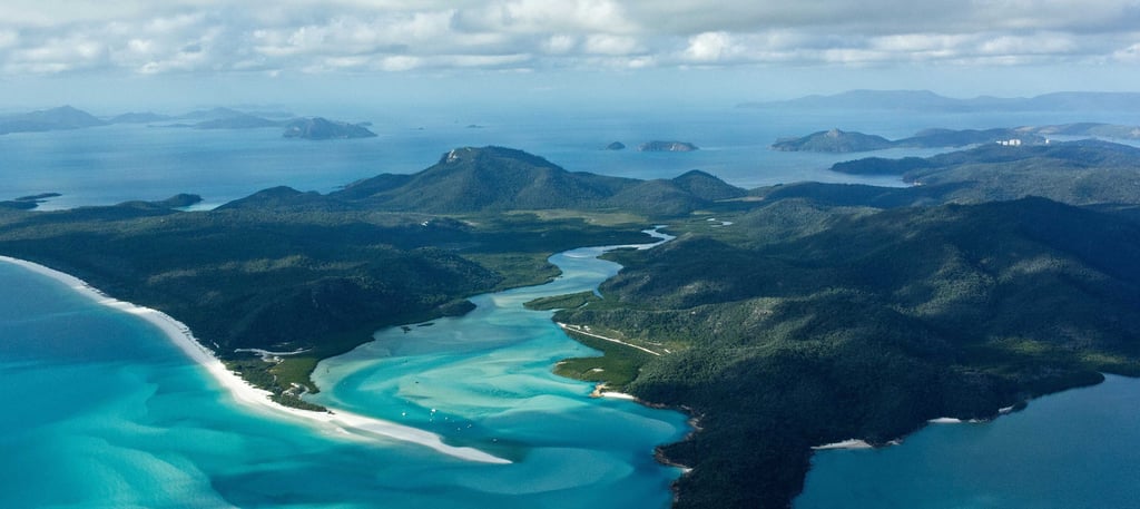 Aerial view of Hill Inlet and Whitehaven Beach with turquoise water and swirling white sands.