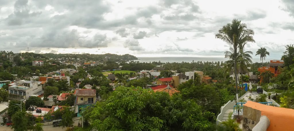 a pool with lounge chairs and a view of the ocean