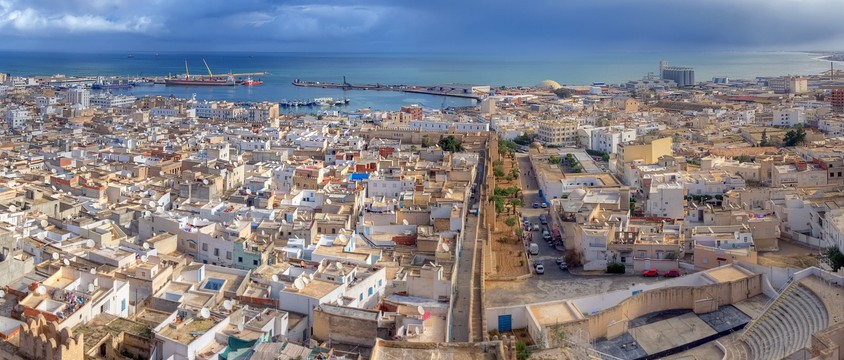 a cityscape of a city with a view of the sea