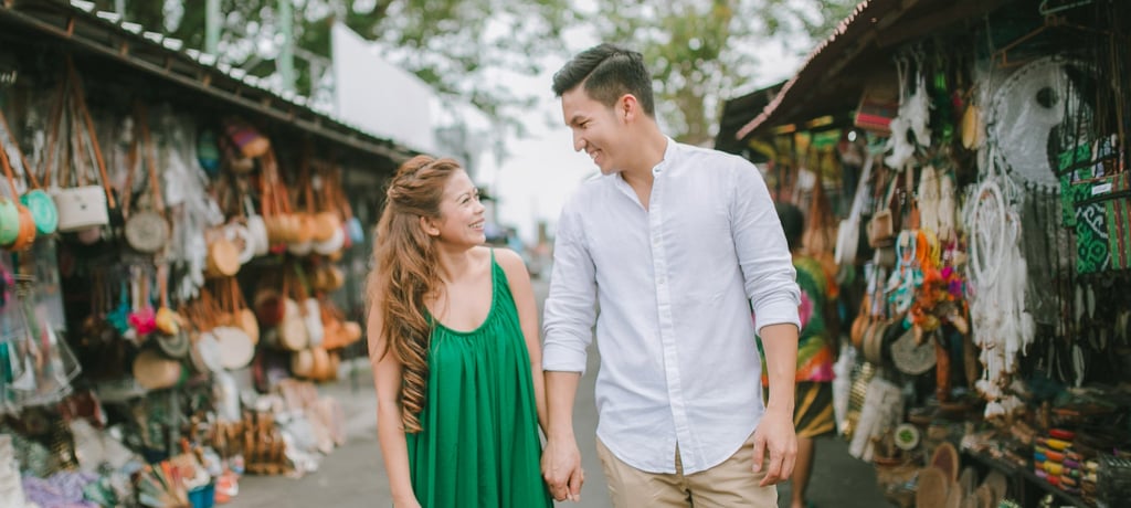 Couple walking through local market area near Tanah Lot Bali during an intimate photography session.