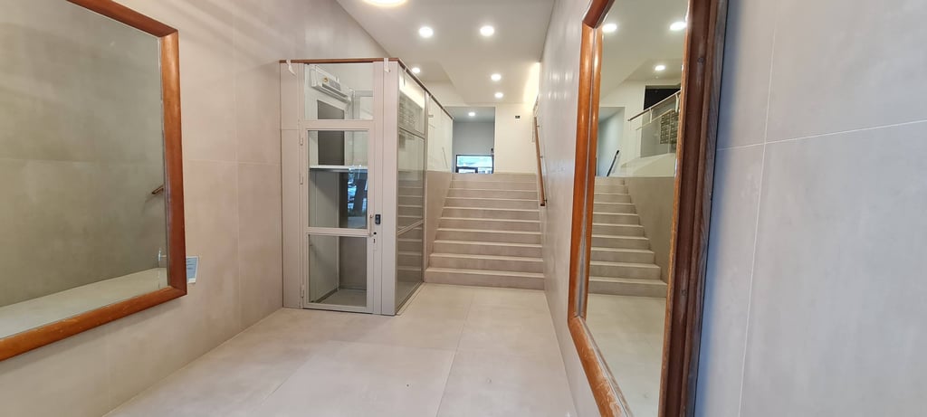 Renovated building entrance with platform lift and elevator, Anne apartment San Sebastian