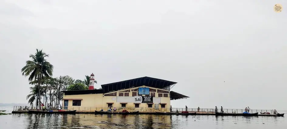 boat house standing alone in the middle of Vembanad Lake near Alleppey, Kerala, surrounded by vast open water.