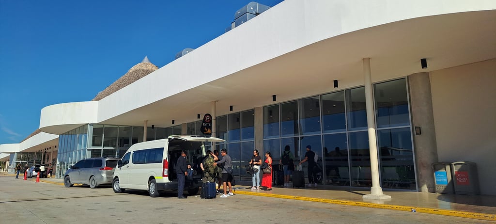 Airport transfer shuttle at Punta Cana International Airport in the Dominican Republic with travelers and luggage.