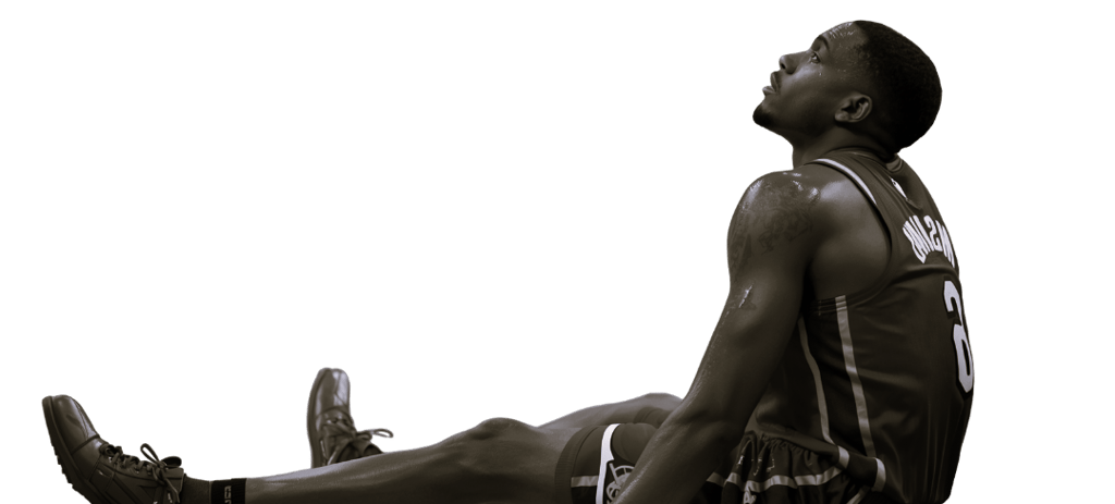 a man sitting on the ground with his feet up and his legs crossed