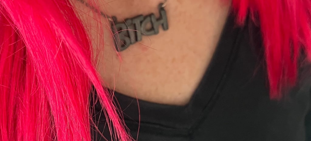 woman-with-red-hair-and-necklace-that-says-bitch