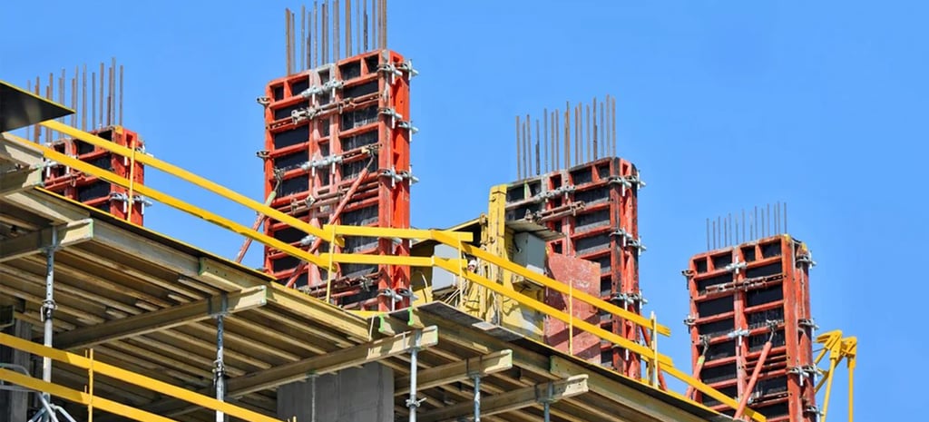 a building with a lot of construction materials and a blue sky