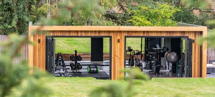 a wooden garden pod gym with fitness equipment