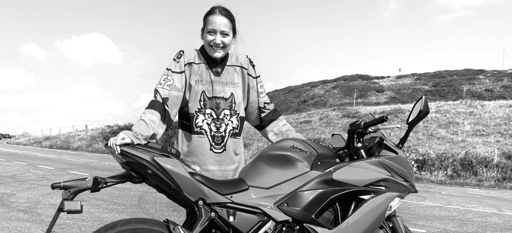 Becky stood next to her Ninja 650 at the side of the road
