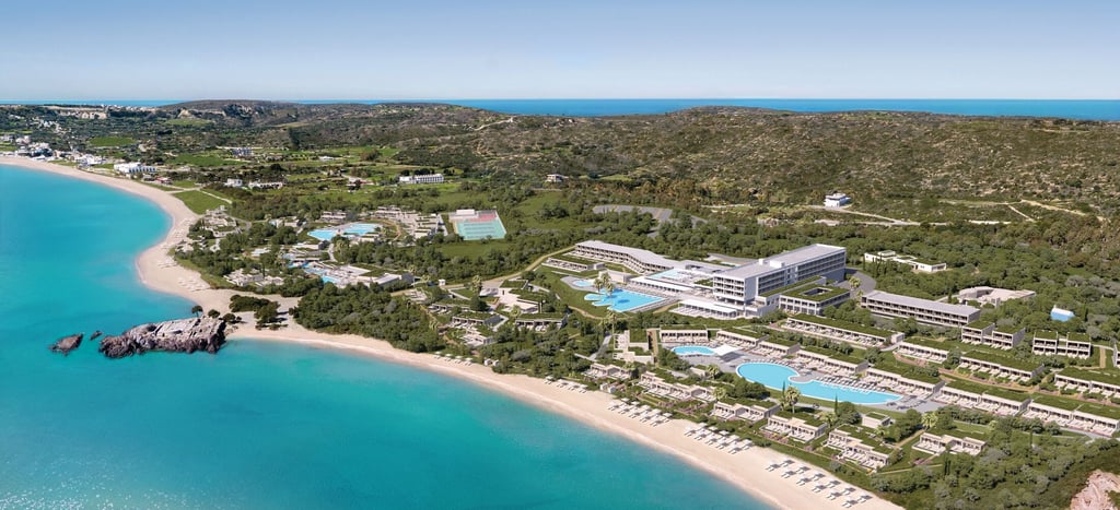 Aerial view of a Ikos featuring multiple swimming pools, modern architecture, and a turquoise ocean.