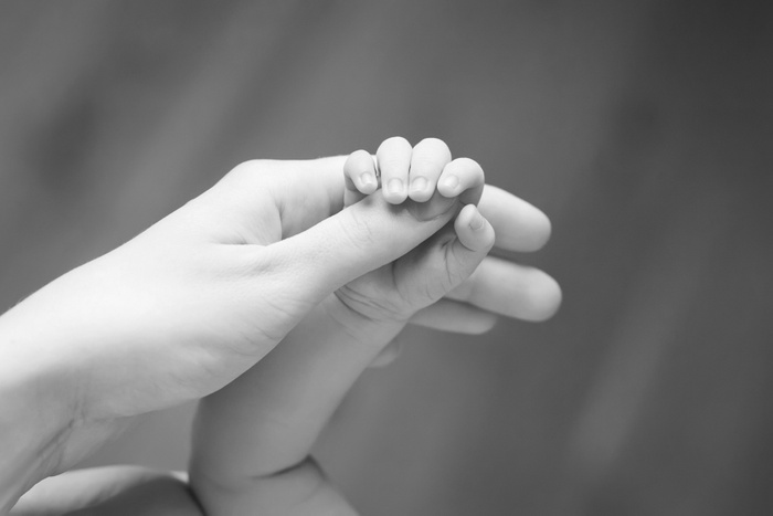 a baby's hand holding a baby's hand