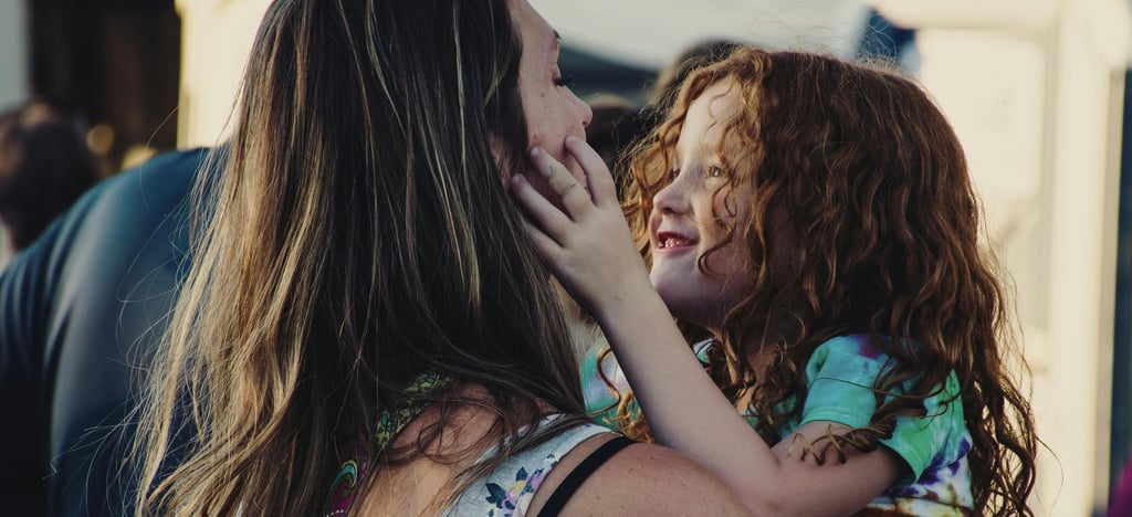 a moher holding and hugging her child