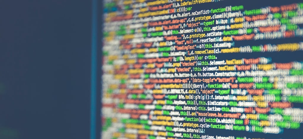 Abstract pattern of multicolored code lines on computer screen, illustrating the digital revolution