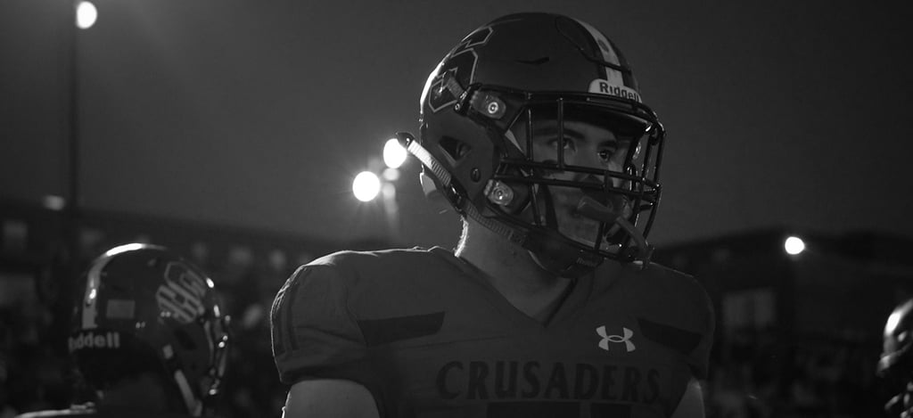a man in a helmet and a helmet on a football field