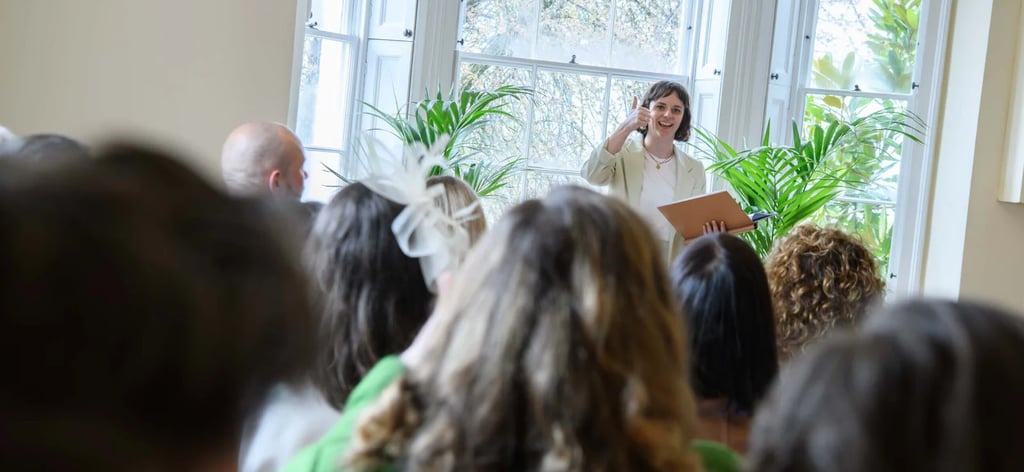 a woman in a white dress standing in front of a crowd of people