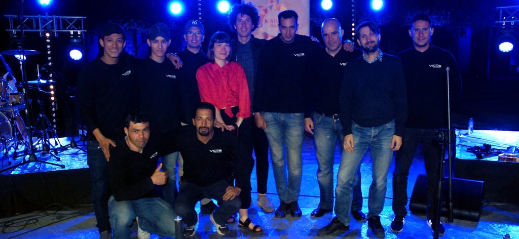 a group of people standing around a stage