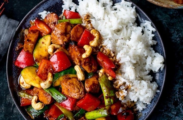 Authentic Kung Pao Chicken served with roasted peanuts, red chilies, and steamed rice.