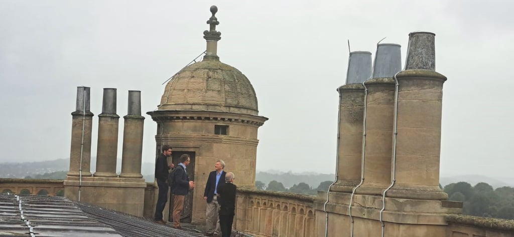 The directors of Byrga Geniht being shown the roof of Wollaton Hall.