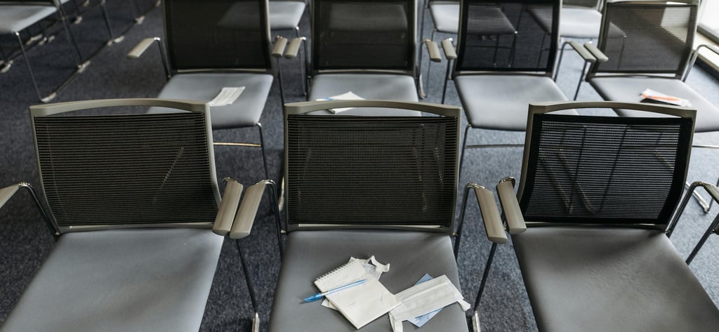 Meeting room with empty chairs symbolizing silence and disengagement caused by psychological safety issues.