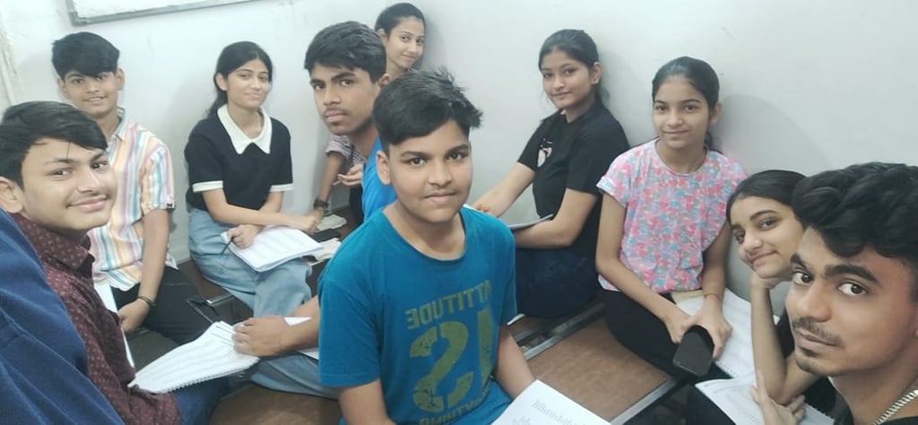 a group of young people sitting on a wooden floor