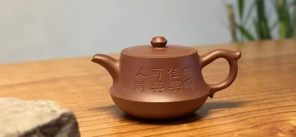 Teapot engraved with characters placed on a wooden table