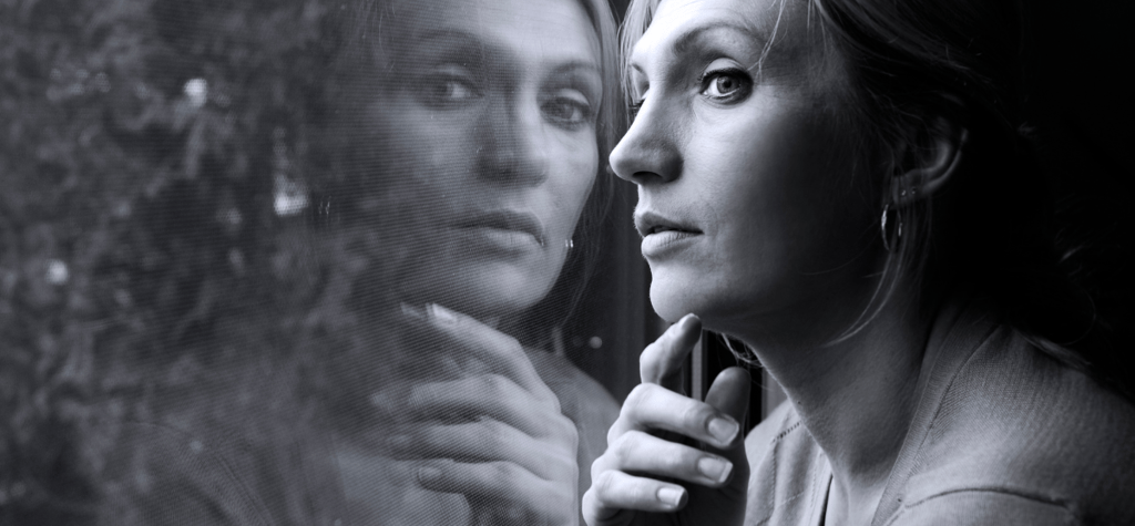 a woman looking at herself in the mirror