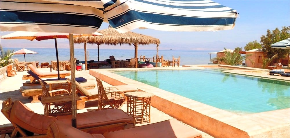 Bedouin star ras shitan lounging under the umbrella