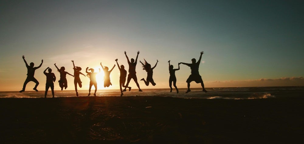a group of people jumping in the air