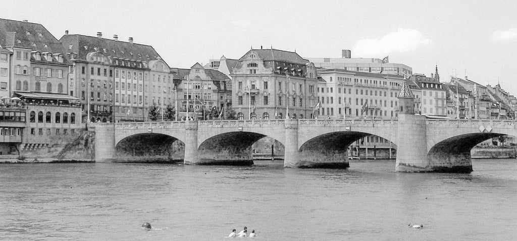 a bridge spanning over a river with several people