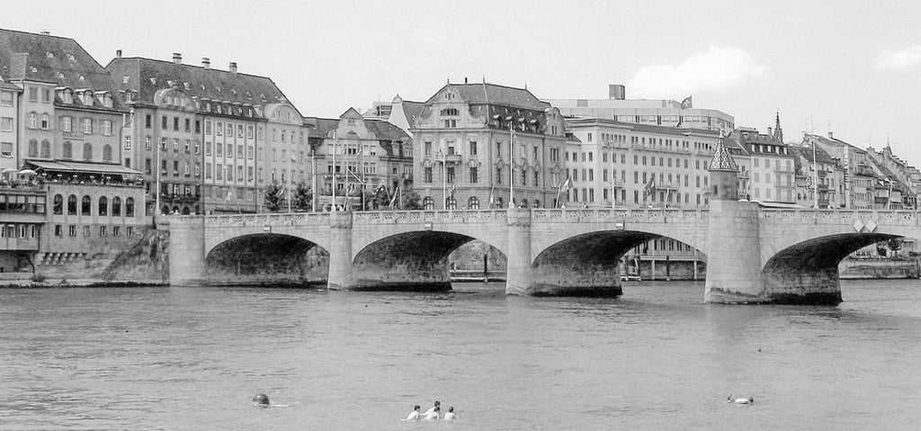a bridge spanning over a river with several people