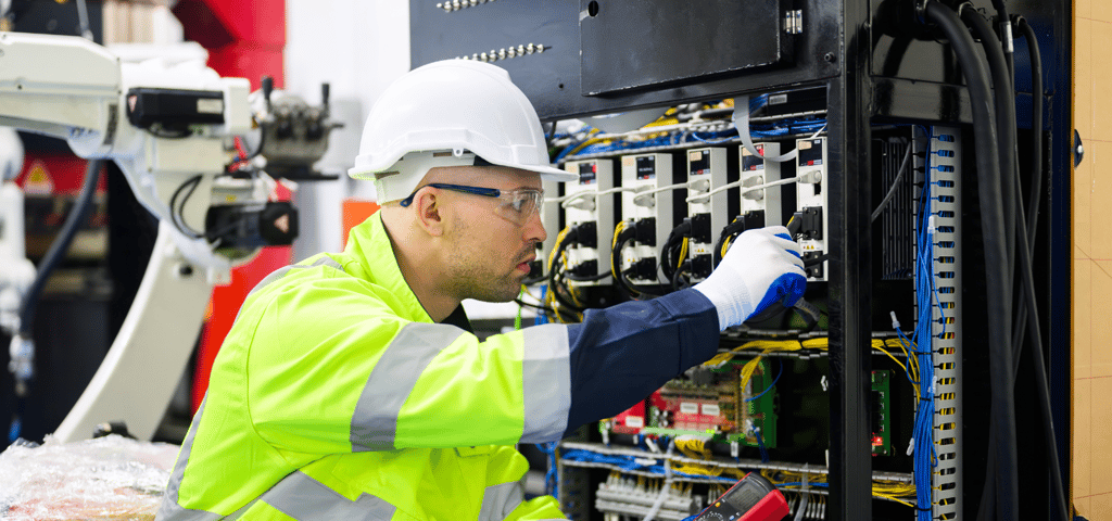 a man in a safety vest and safety glasses