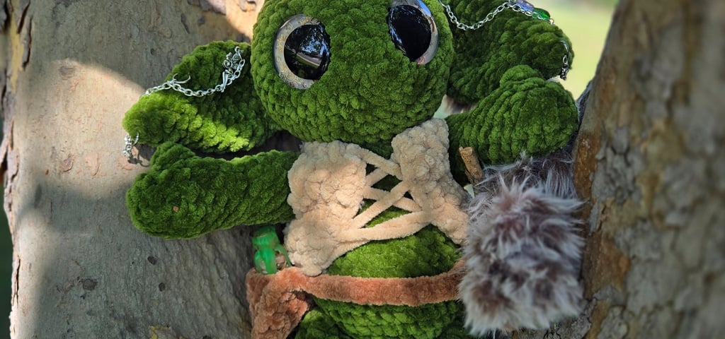 Handmade green goblin plushie with faux fur accents, leather-style vest, and chain accessories, pose