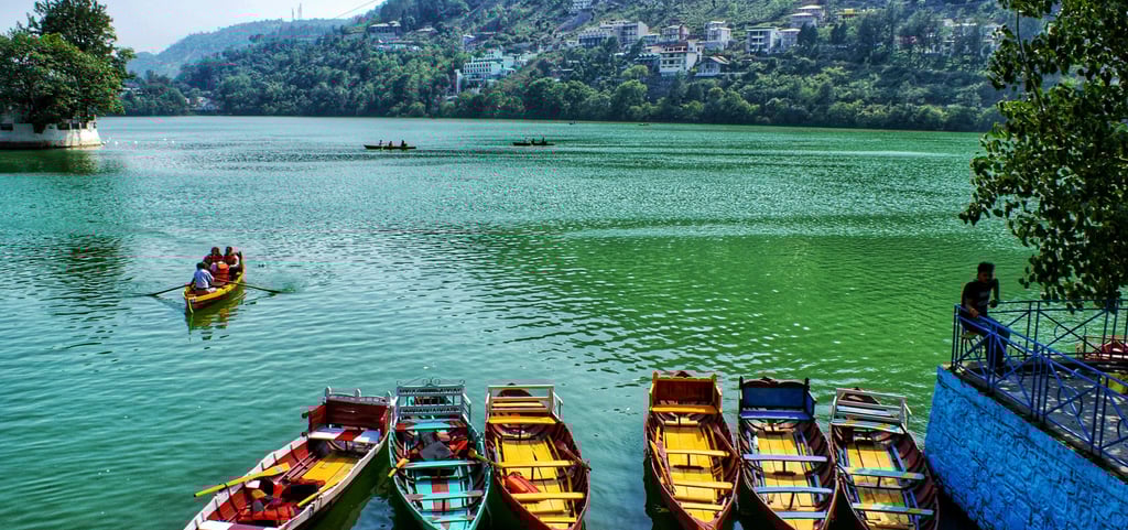 a group of people in a row boat on a lake