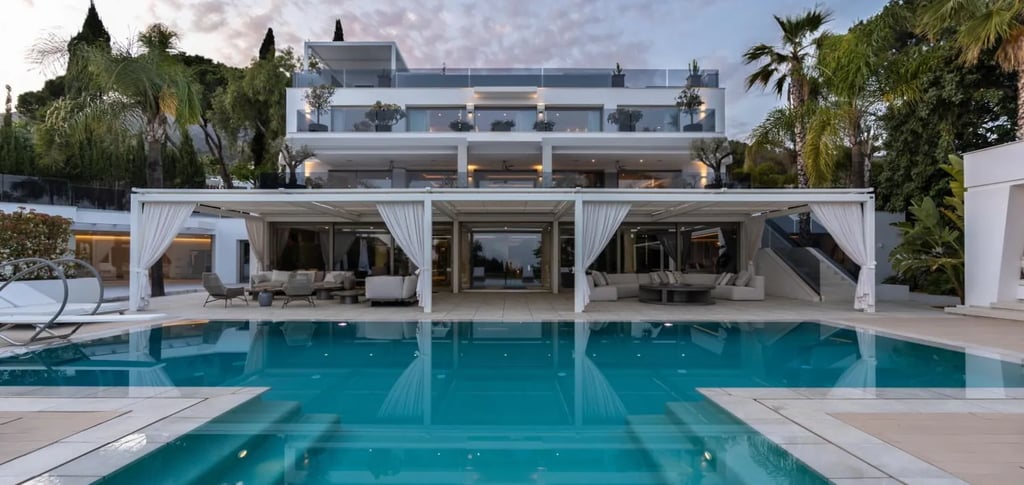 Villa Serenity poolside view with white façade and terraces