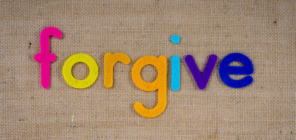 a colorful word written in the word forgive