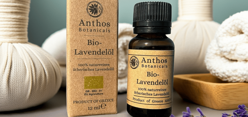 a box and a bottle of lavender essential oil and lavender flowers