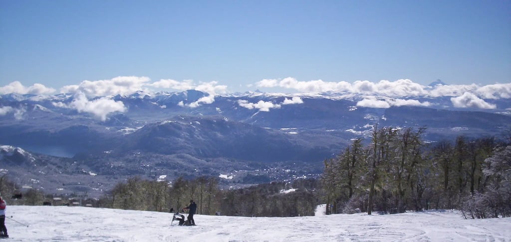 a person standing on a snowy mountain top chapelco argentina