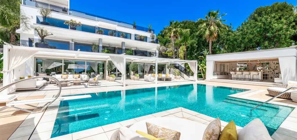 Luxury poolside view of Villa Serenity with palm gardens