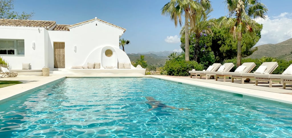 Main pool terrace with sun loungers and palm trees