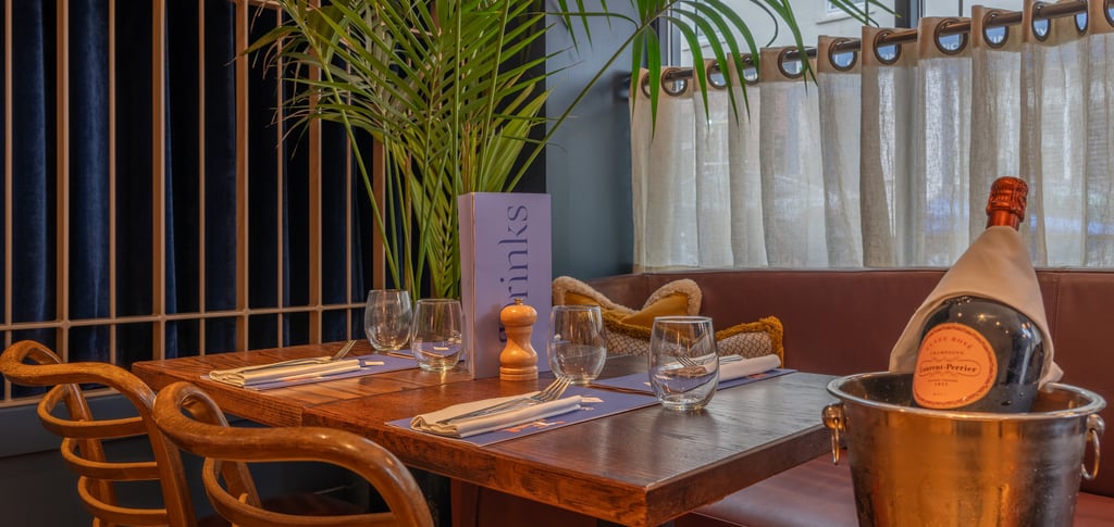 a restaurant table with a bottle of champagne and a bottle of champagne